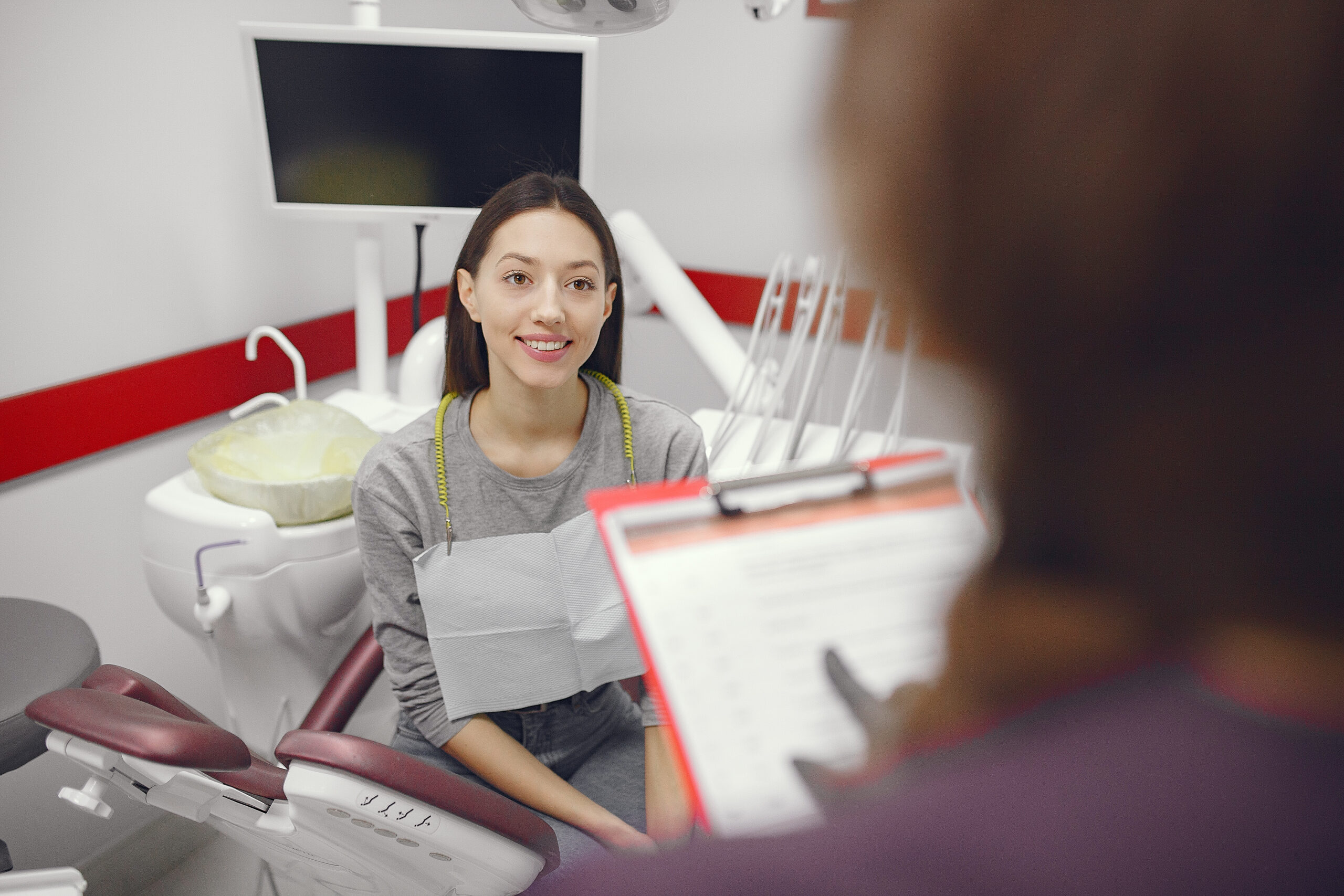 Beautiful lady in the dentist's office. Woman in a purple uniform