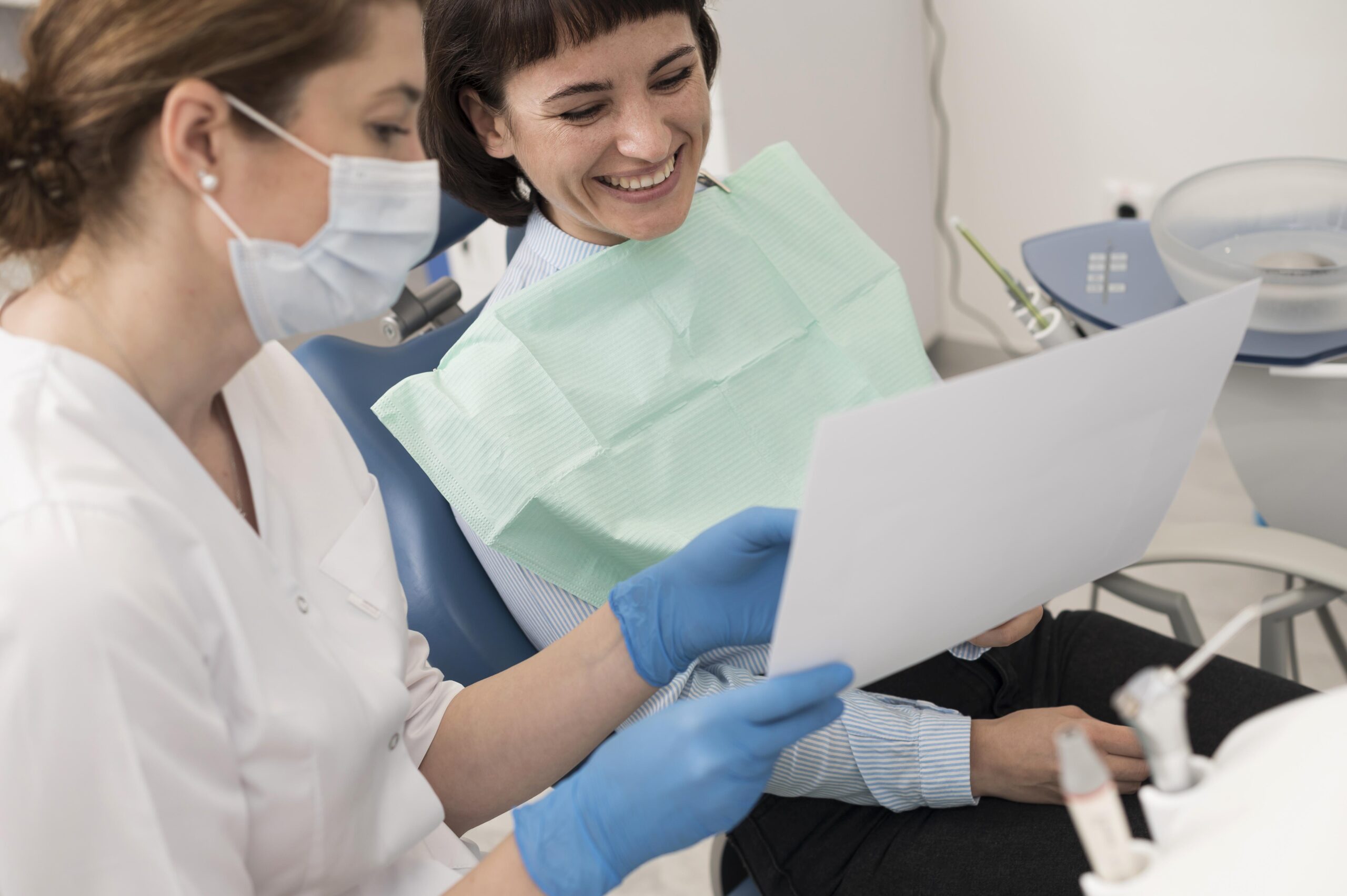 female-patient-looking-radiography-her-teeth-with-dentist