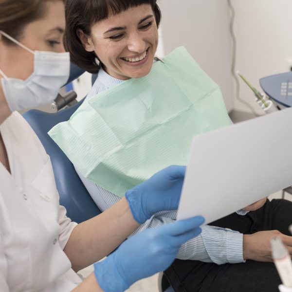 female-patient-looking-radiography-her-teeth-with-dentist